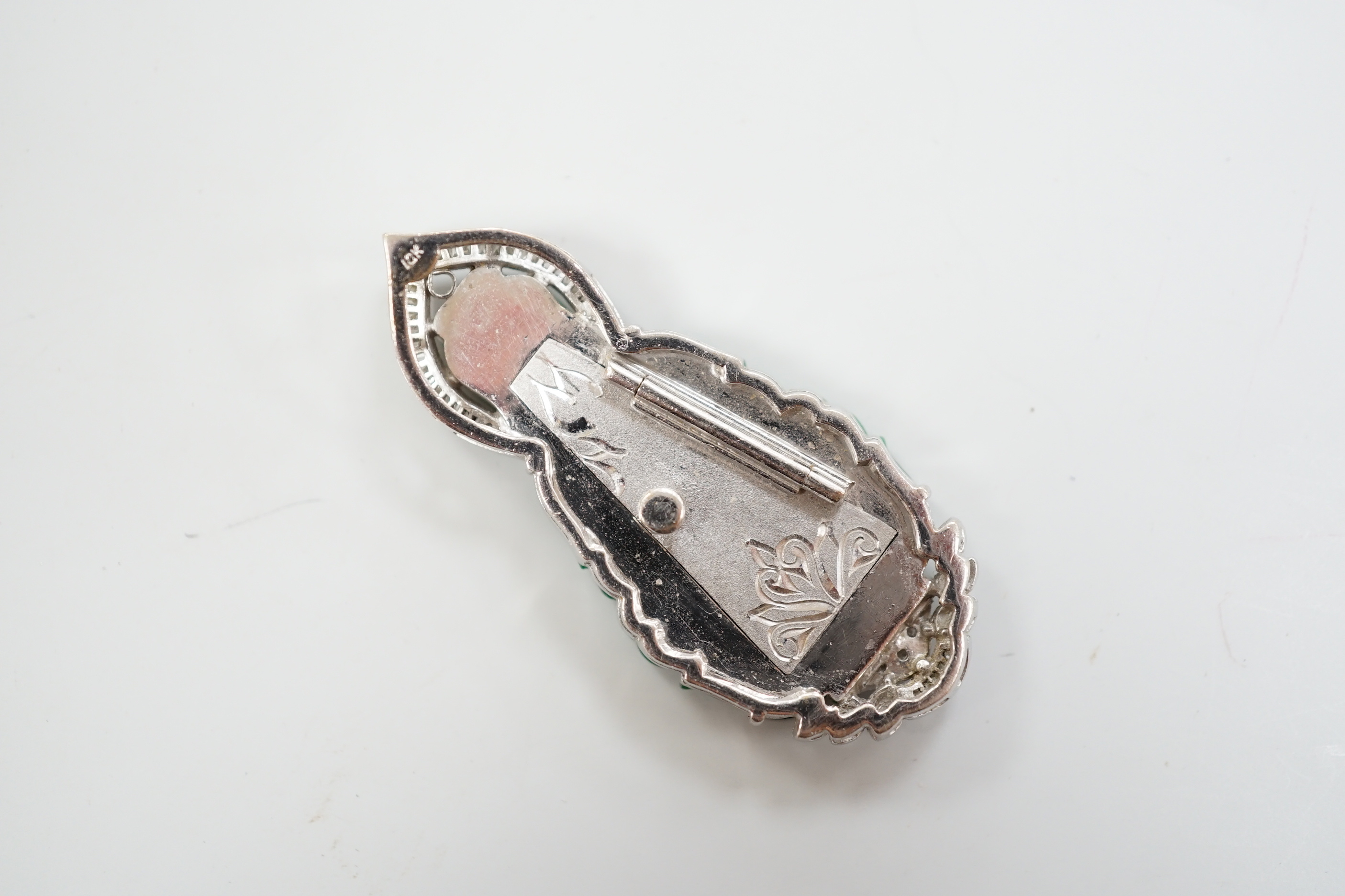 An 18k, baguette and round cut diamond cluster set carved jade figural pendant, the back with engraved hinged door, 47mm, gross weight 15.4 grams.